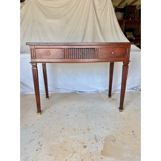 Found in the Provence Region of France, this 19th Century Louis XVI Walnut Console Table dates back to the late 1800's....