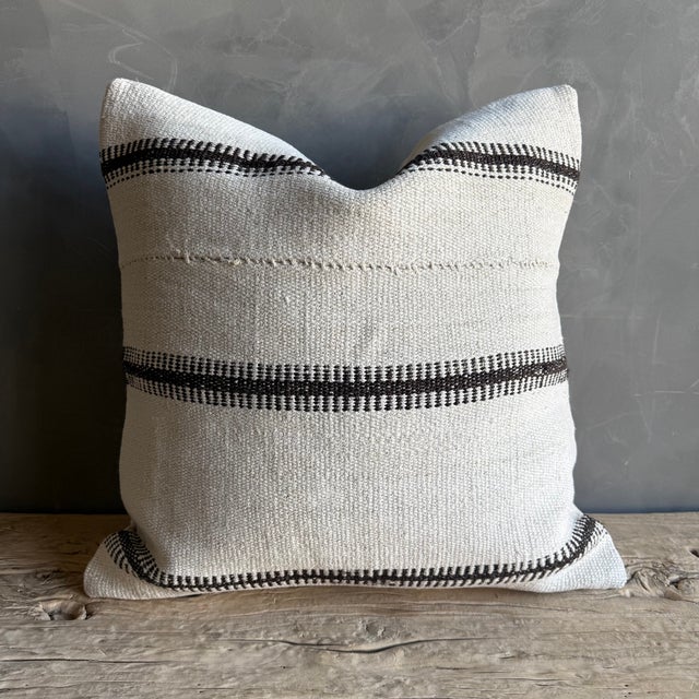 Creamy white hemp rug pillow with stripes. Soft hand, linen blend backing with zipper closure. Spot cleaning is...