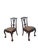 A striking set of four Chippendale-style mahogany dining chairs distinguished by elaborate carving, pierced splat backs,...