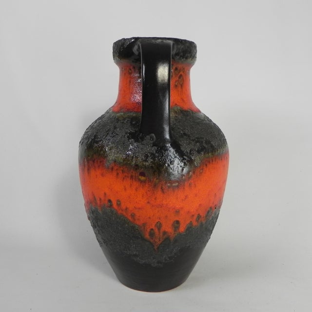 Large orange and brown "Fat Lava" pitcher vase from the 1960s, manufactured by Carstens Tönnieshof in West Germany. The...
