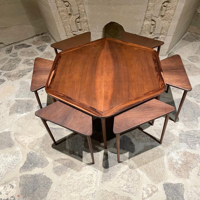 AMBIANIC presents: Set of 6 rosewood nesting tables tucked underneath hexagonal coffee table. Made Denmark 1950s Set...