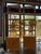 A stylish pair of Italian mid-century étagère bookcases crafted from natural bamboo with woven rattan accents, dating to...