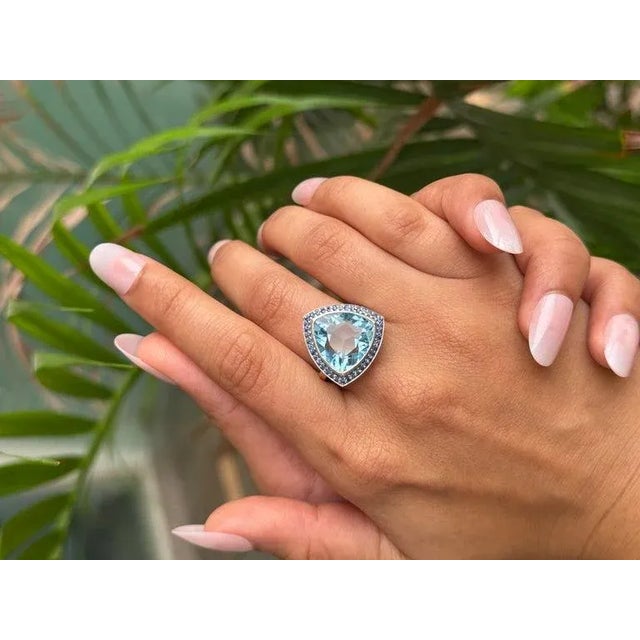 This Antique Style Faceted Trillion Natural Topaz & Sapphire Cocktail Silver Ring statement cocktail ring showcases a...