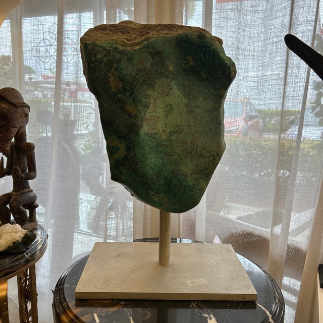 This is a large raw nephrite jade gemstone boulder specimen. It has hues of green as well as some darker areas. It's a...