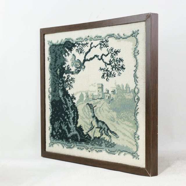 This vintage needlework captures a classic pastoral scene in a sophisticated monochrome palette of teal and soft cream....