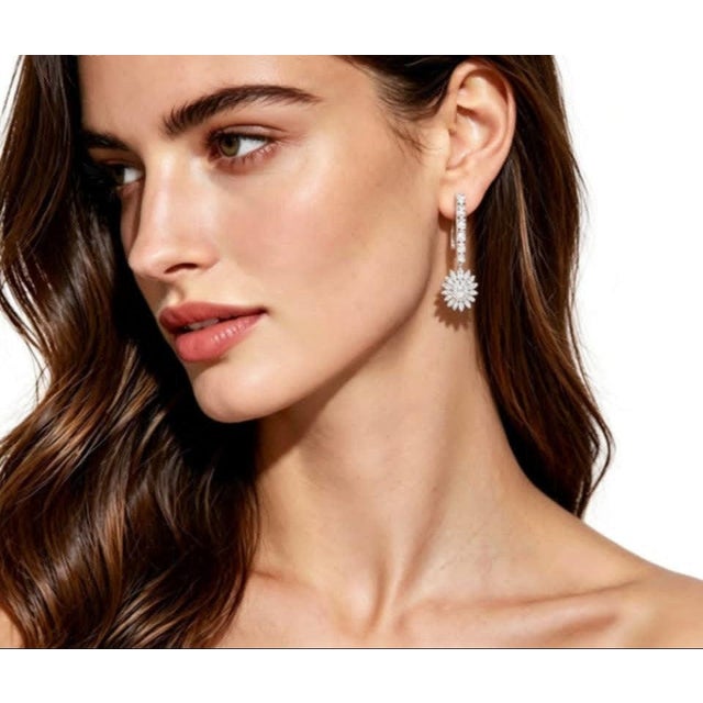 Add elegance with this gorgeous pair of 18K white gold earrings, featuring a sunflower design adorned with brilliant round...