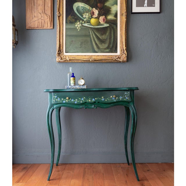 Layers of beauty and charm adorn this antique Louis XV-style writing desk, with a lovely scalloped edge along the table...