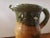 This 1940's Clay Puzzle Jug measures 8 1/4" high, 7" wide and 4 1/2" deep. The piece is in very good overall condition...
