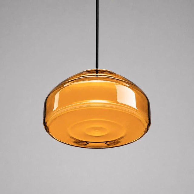 Crafted with high visual clarity, this modern pendant lamp features a sleek silhouette hand-blown from premium glass in a...