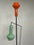 A 1950s floor lamp produced by Vetreria Laguna Murano. It stands out for its minimalist black lacquered iron frame with...