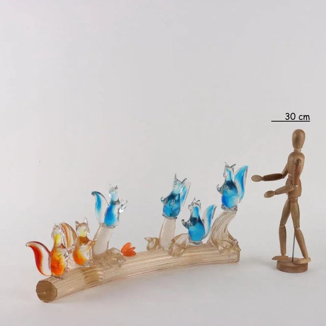 Polychrome glass sculpture with gold leaf inclusions depicting group of squirrels on tree trunk. This piece is attributed...