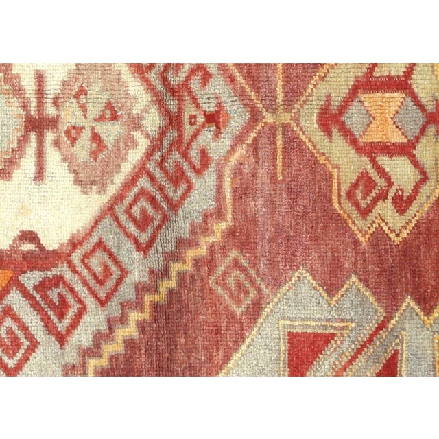 Handwoven wool-on-wool Oushak rug from vintage Turkey, measuring 4'10" x 8'. Originating from the storied weaving...