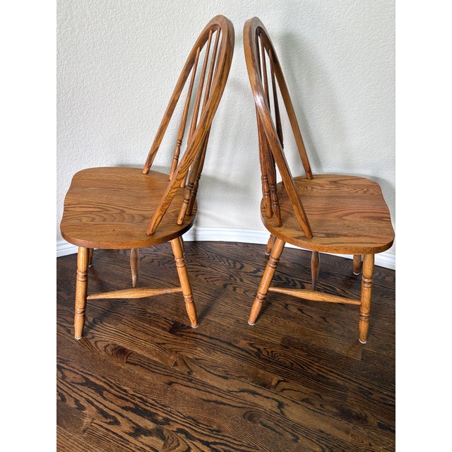 Bring timeless American craftsmanship to your dining room or breakfast nook with this handsome pair of solid oak Windsor...