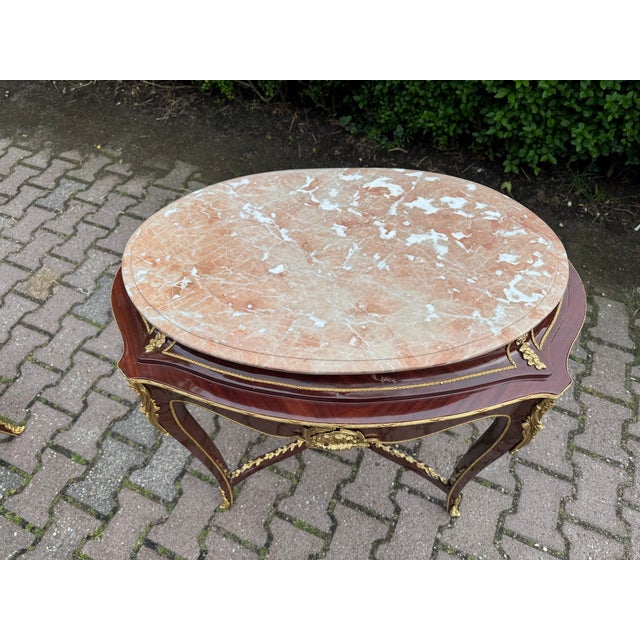 A refined French Louis XVI-style side table from teh first half of the 20th century, beautifully crafted from mahogany and...