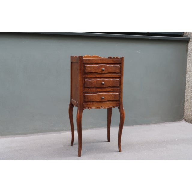 French antique side table nightstand. Parisian work from the middle of the XXth century. It opens with three drawers. Very...