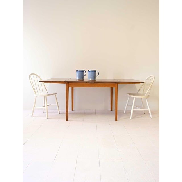 Modern dining table of Scandinavian origin with removable wings. Original Swedish vintage. The table is equipped with two...