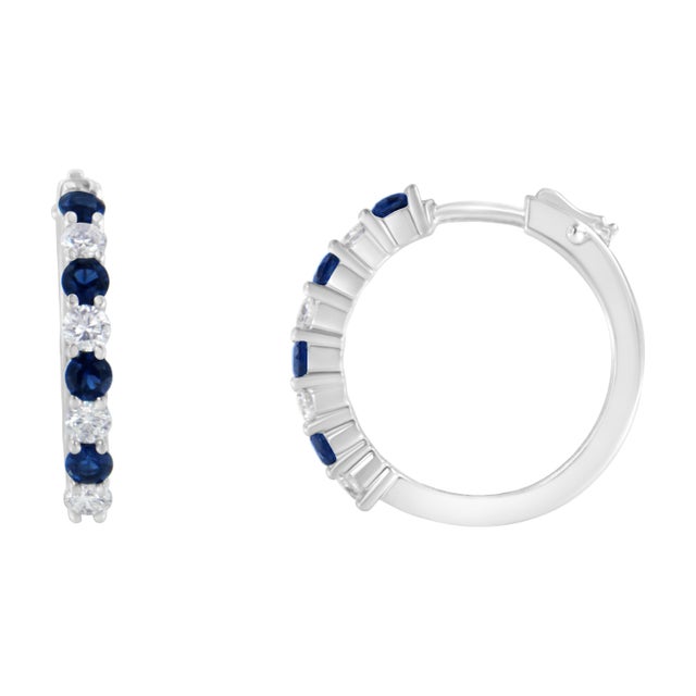Elegant and classic, these stunning hoop earrings are fashioned in 10k white gold. Sparkling 1/2ct TDW of round cut...