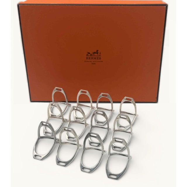 A lovely set of 12 signed vintage Hermes stirrup napkin rings. Gift box included. Excellent condition.