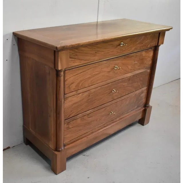 Refined Bicentennial Chest of Drawers in Solid Walnut. Its Tabbed Top tops a Projection Belt opening on a Drawer, narrower...