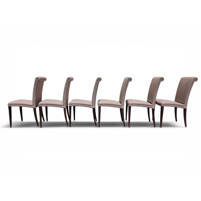 This set of six chairs is the "vittoria" model, a renowned, high-quality creation by poltrona frau. featuring a modern and...