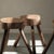 Brutalist coffee table with four stools, made from solid cross-section tree slices on tripod bases, circa 1960. Each piece...