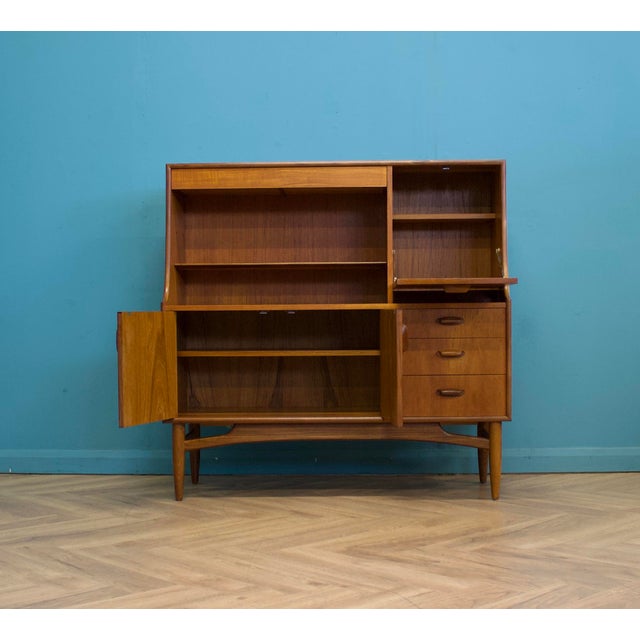 A highboard or drinks cabinet by G Plan for the Brasilia range - Circa 1960s Featuring a pull down drinks cabinets, a...