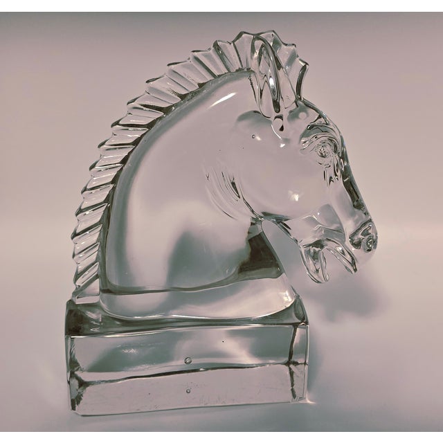 Strikingly beautiful, Heisey glass piece, specifically a horse head paperweight. It was made by Heisey Glass, a company...