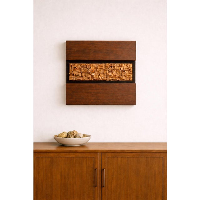 “Assemblage 102” is an original mixed-media wall sculpture by artist Craig Griffin. Measuring 13.5” high by 14” wide, the...