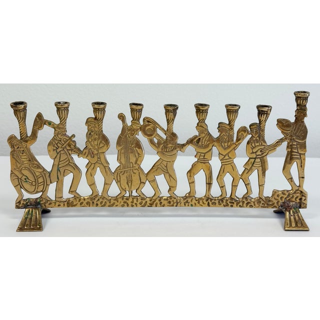 Vintage solid brass menorah featuring musicians with their instruments. Holds skinny taper candlesticks. Makes a great...