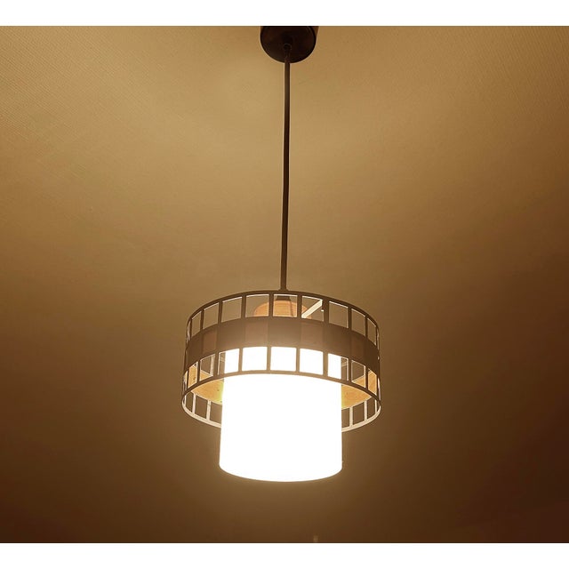 Danish Modern pendant light featuring an opaline glass shade with a light pinstriped pattern and a copper and black...