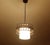 Danish Modern pendant light featuring an opaline glass shade with a light pinstriped pattern and a copper and black...