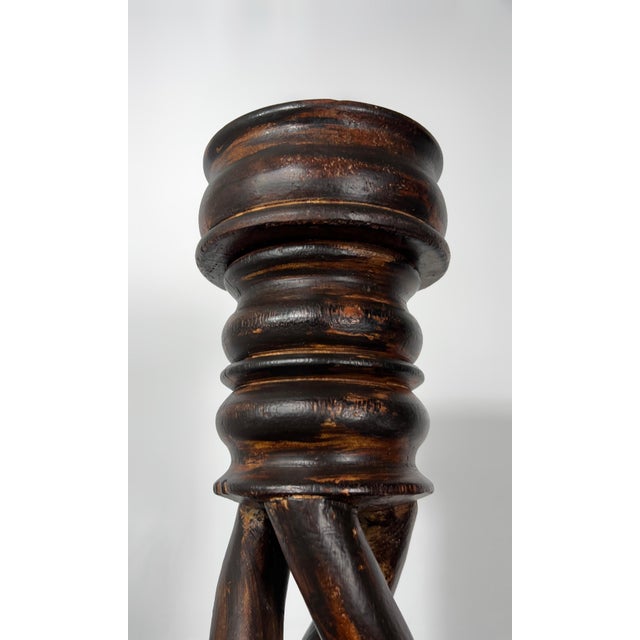 This 27-inch antique candlestick is a masterclass in architectural woodcraft, featuring a rare and dramatic triple open-...