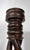 This 27-inch antique candlestick is a masterclass in architectural woodcraft, featuring a rare and dramatic triple open-...
