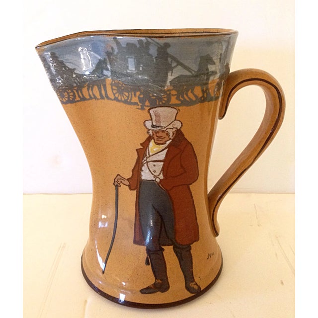 English Royal Doulton jug with pinched spout has lovely brown glaze with the image of a squire on one side and village on...