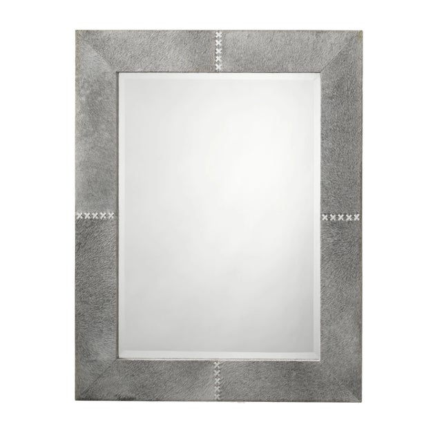 This generously sized beveled wall mirror is edged in hair-on-hide and accented with a contrasting leather cross stich....