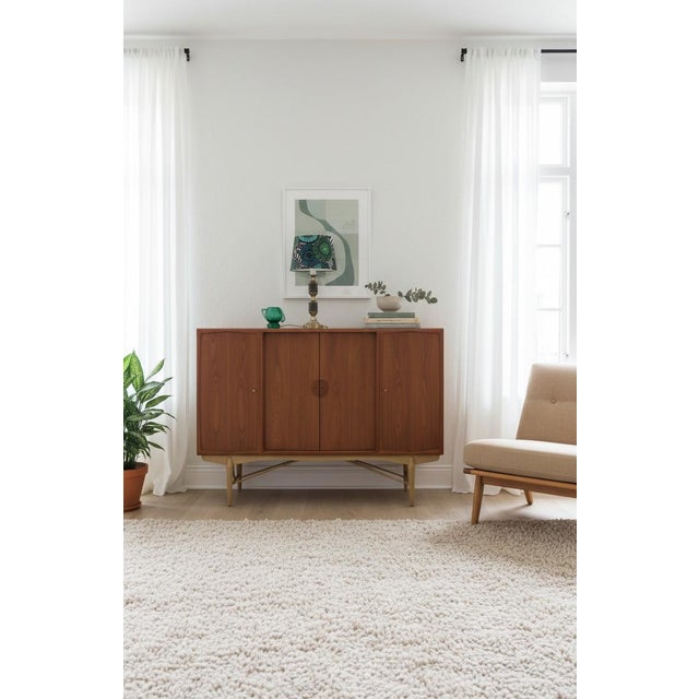 An incredibly well-built and beautiful Dansk cabinet! The cabinet is in teak with tasteful oak legs. The cabinet has four...