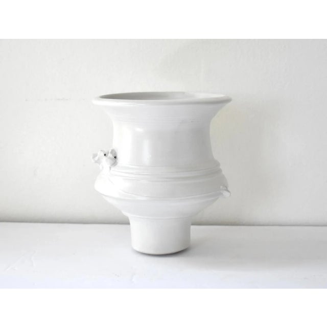 A minimalist, organic modern white glaze over white porcelain studio art pottery vase or vessel, hand-thrown, with slip...