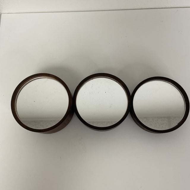 A set of three vintage, stackable wooden plateau featuring round mirrored tops with felt bottoms. These versatile pieces...