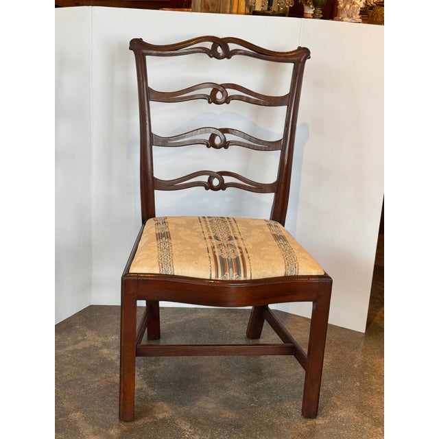 A set of ten late 19th century mahogany dining chairs with shaped backs featuring pierced and curved horizontal splats,...