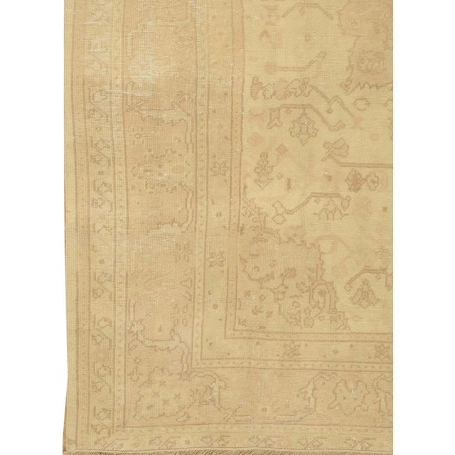 Antique shabby chic Oushak rug, circa 1920. Light-colored Oushaks are among the most popular oriental carpets, known for...