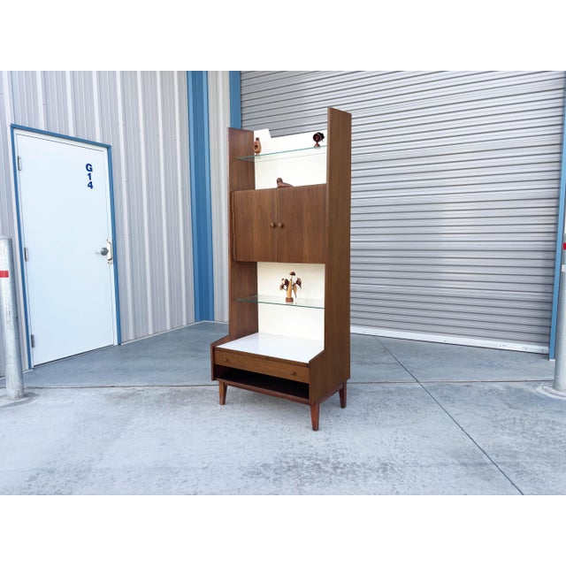 This striking Mid-Century Modern cabinet, designed by Kipp Stewart and made in the United States circa the 1960s, is a...