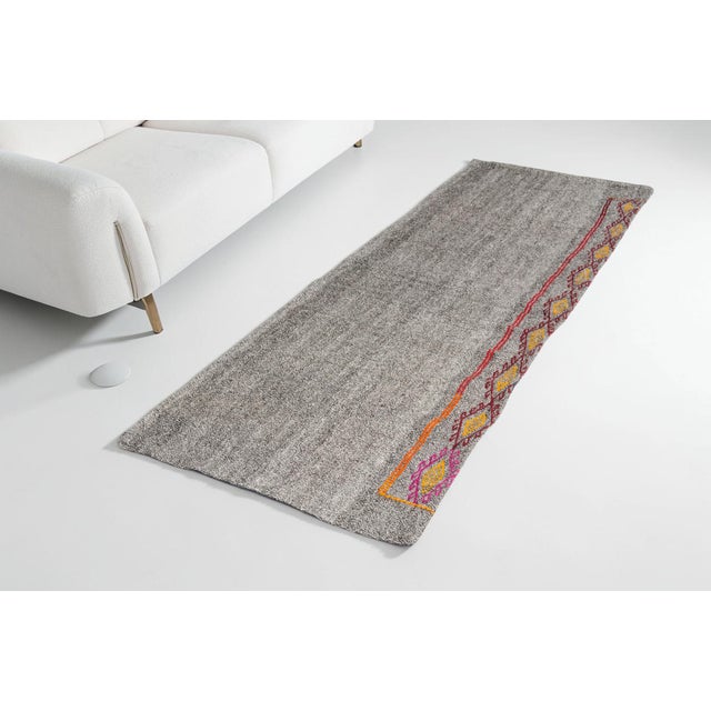 This is a vintage Turkish Oushak rug from the Mid 20th Century. The piece was hand-knotted.