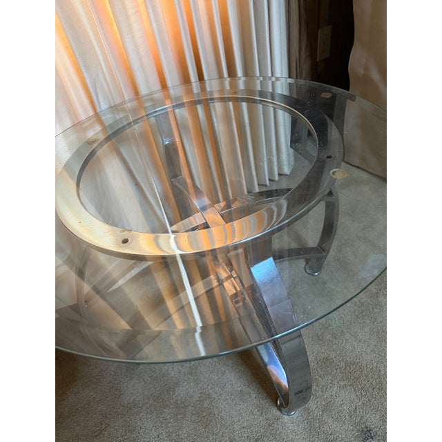 Mid century chrome and glass table set includes two round end tables and one oval coffee table both with beveled edge...