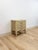 This lovely vintage Ficks Reed style faux bamboo nightstand is a warm and beautifully crafted coastal and Hollywood...
