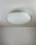 Elegant and minimalist flush-mount light made of a frosted murano glass diffuser with a transparent handmade rim and a...