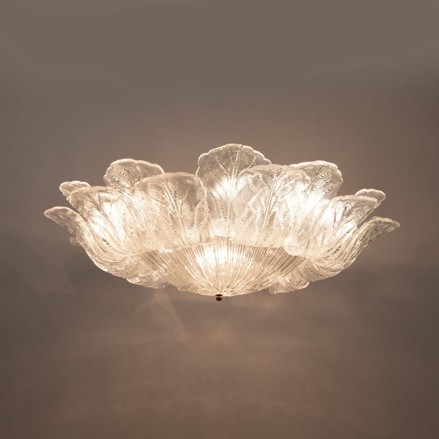 This large and elegant italian ceiling light features murano glass leaves arranged in a rich floral composition. Each...
