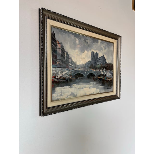 A captivating 1970s vintage Impressionist oil on canvas painting depicting a moody Parisian street scene, featuring the...