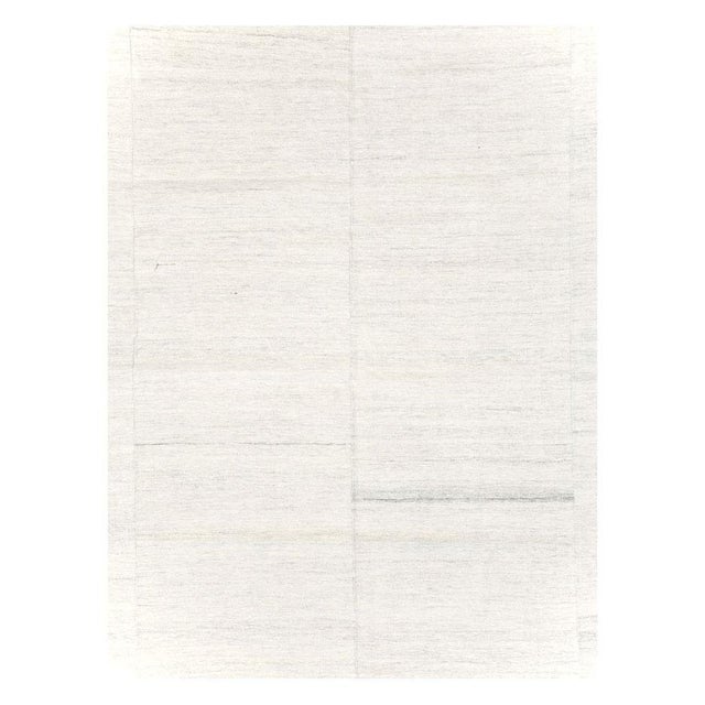 A vintage Turkish flatweave Kilim room size carpet in shades of white and grey handmade during the mid-20th century....
