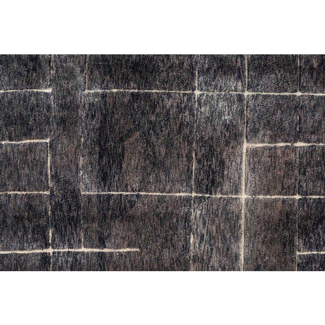 Striking hand-knotted wool rug in Midnight Navy, Deep Taupe, Blue Indigo, and Ivory. Showcasing a refined grid pattern,...