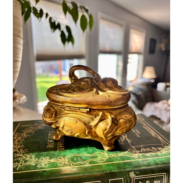 Stunning, gold art nouveau early 1900s footed jewlery box. Can be used as an home accent piece or trinket box. Over 100...